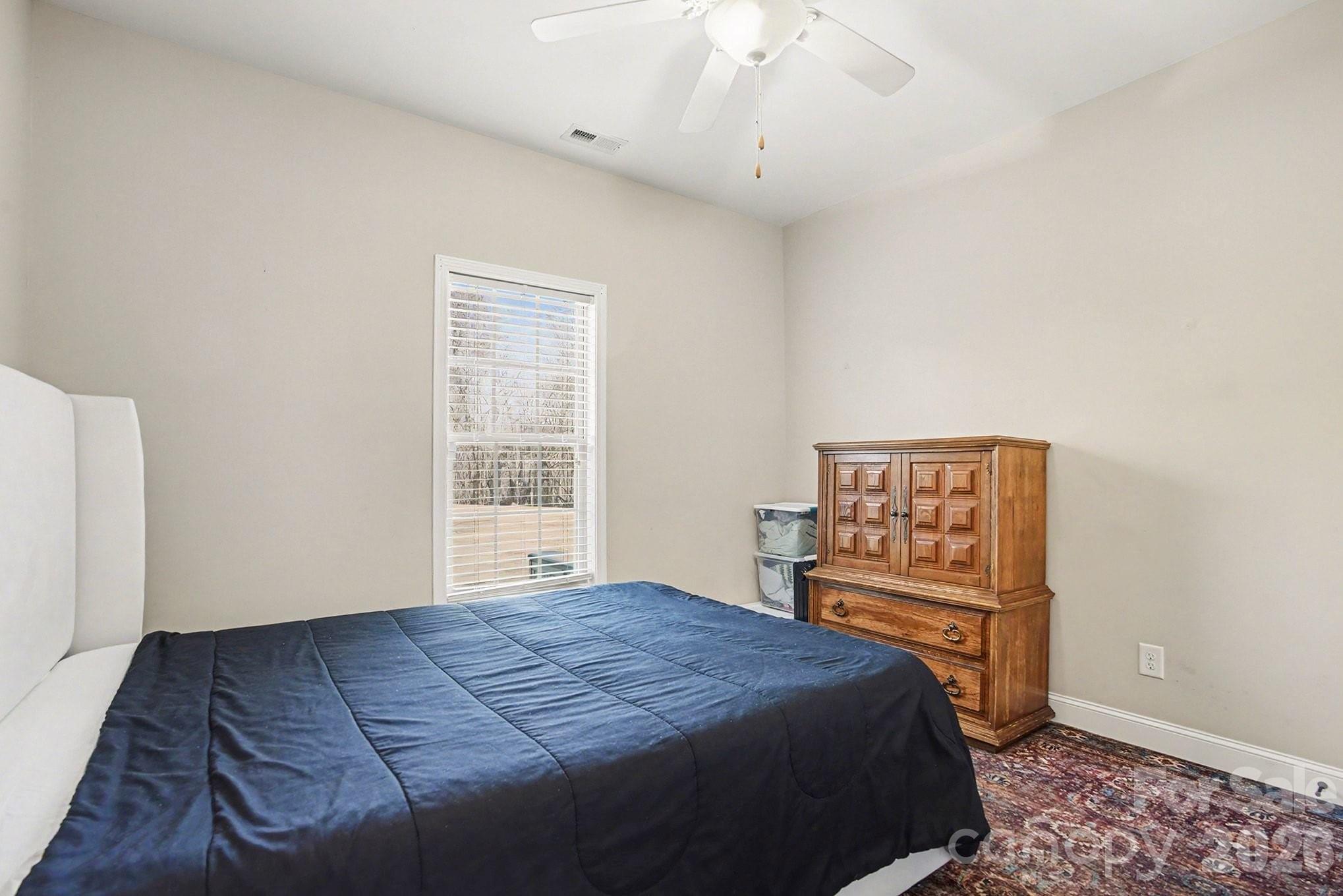 311 Massey Deal Road Statesville, NC 28625 - Photo 19 of 34 a bedroom with a bed and a cabinets