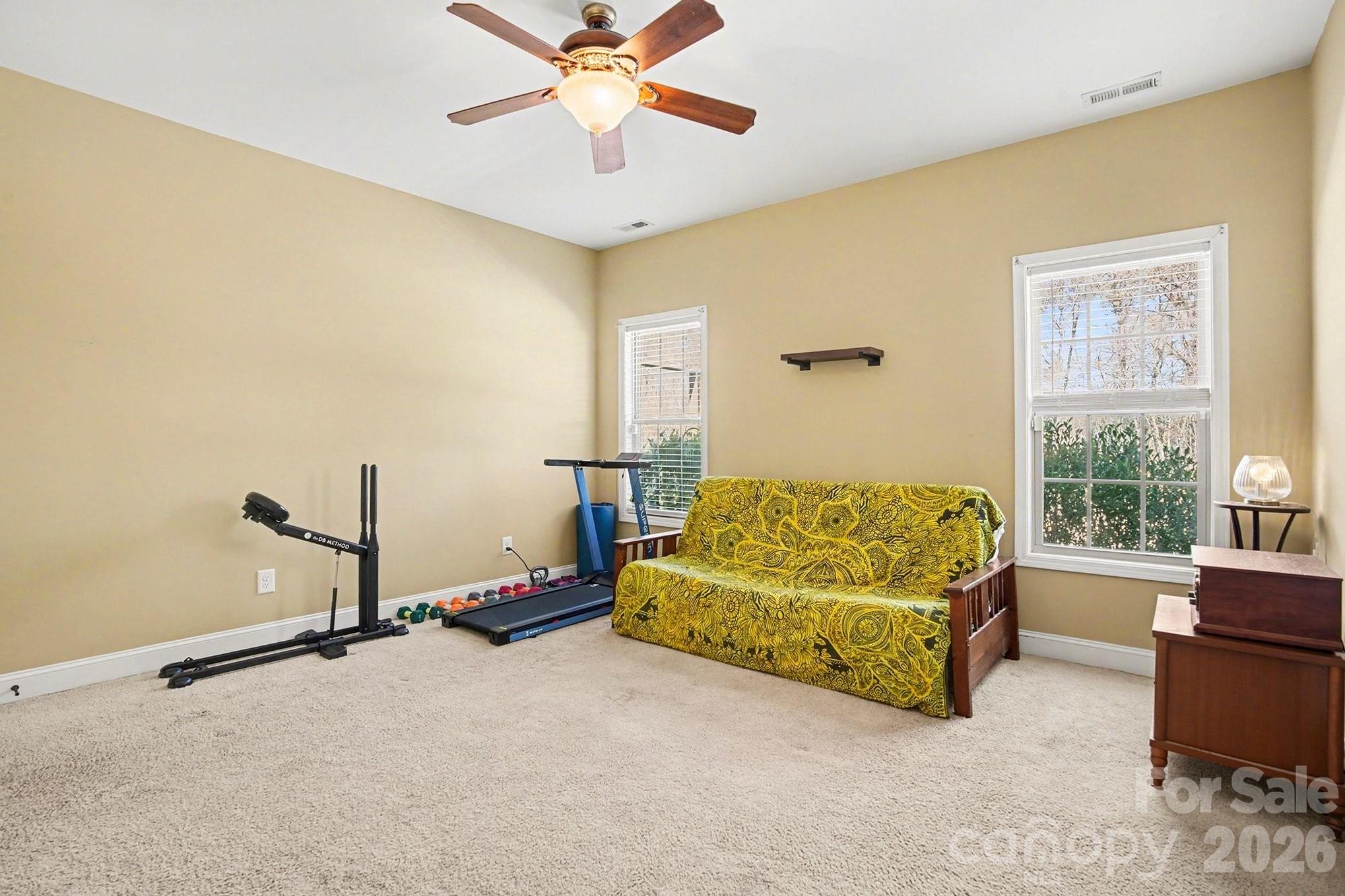311 Massey Deal Road Statesville, NC 28625 - Photo 26 of 34 a bedroom with a bed and a chandelier
