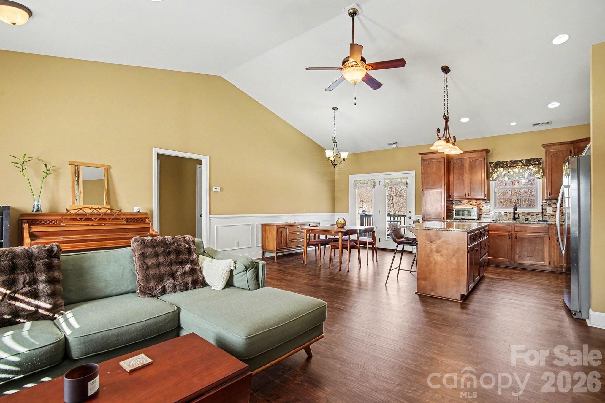 311 Massey Deal Road Statesville, NC 28625 - Photo 7 of 34 a living room with furniture kitchen view and a chandelier