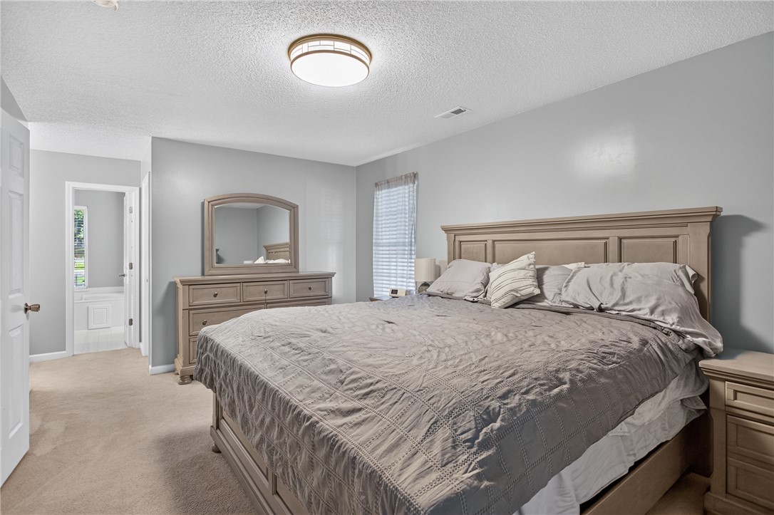 3336 Centerville Road Anderson, SC 29625 - Photo 22 of 50 An inviting sleeping space offers plush carpeting and a private entrance to the adjoining bath.