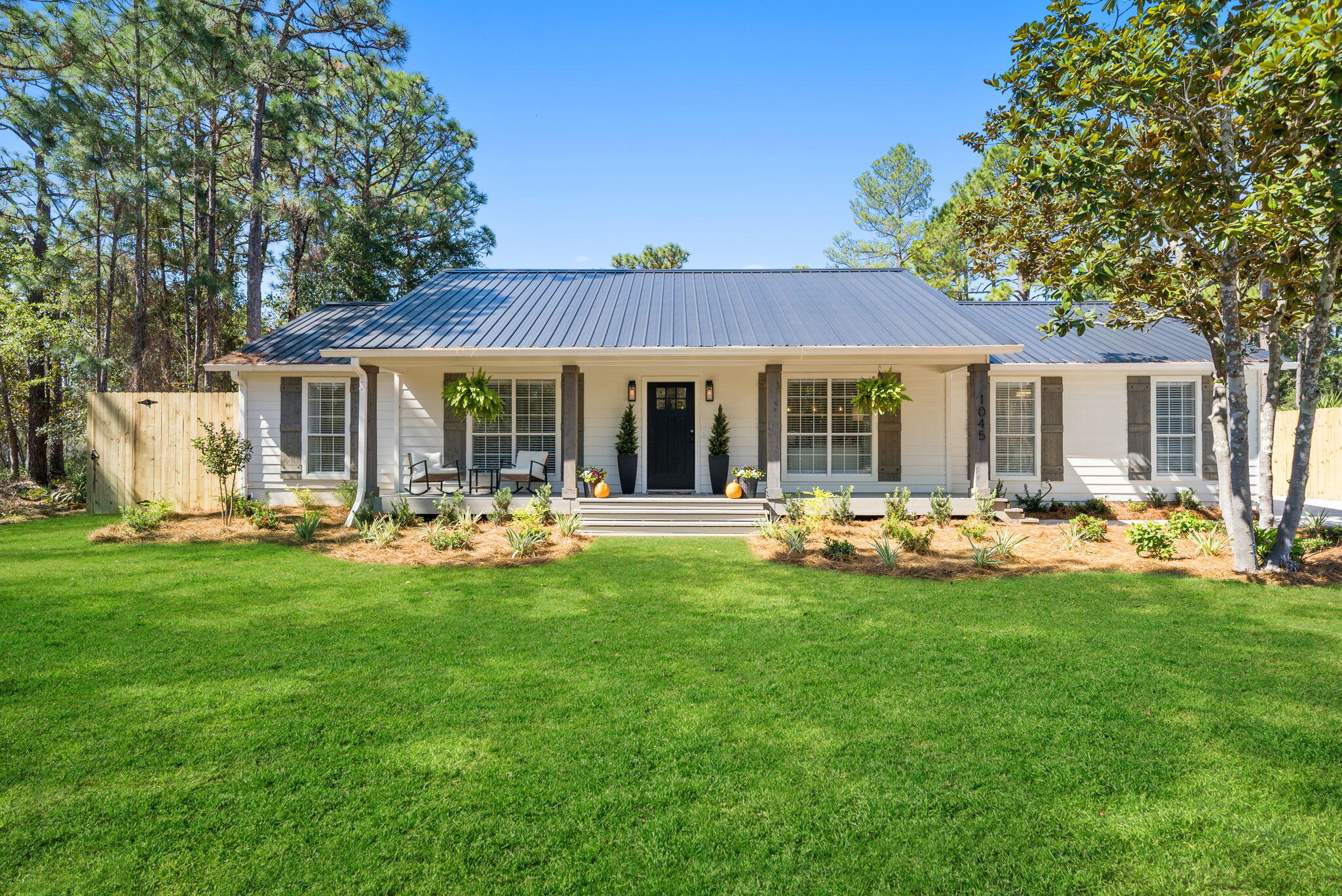 1045 Don Bishop Road Santa Rosa Beach, FL 32459 - Photo 1 of 37 a view of a house with patio and a garden