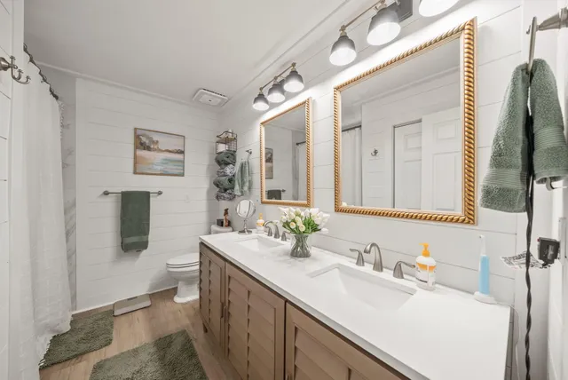 a bathroom with a sink vanity granite and a mirror