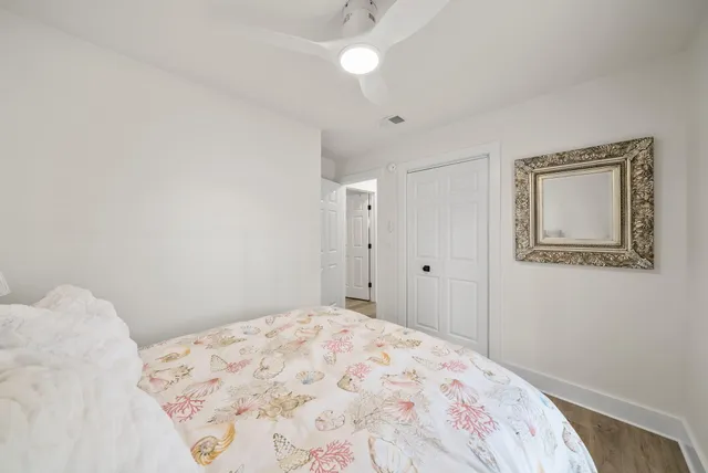a bedroom with a bed and a lamp on the dresser