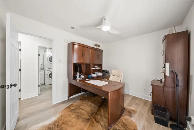 a room with furniture a mirror and a ceiling fan