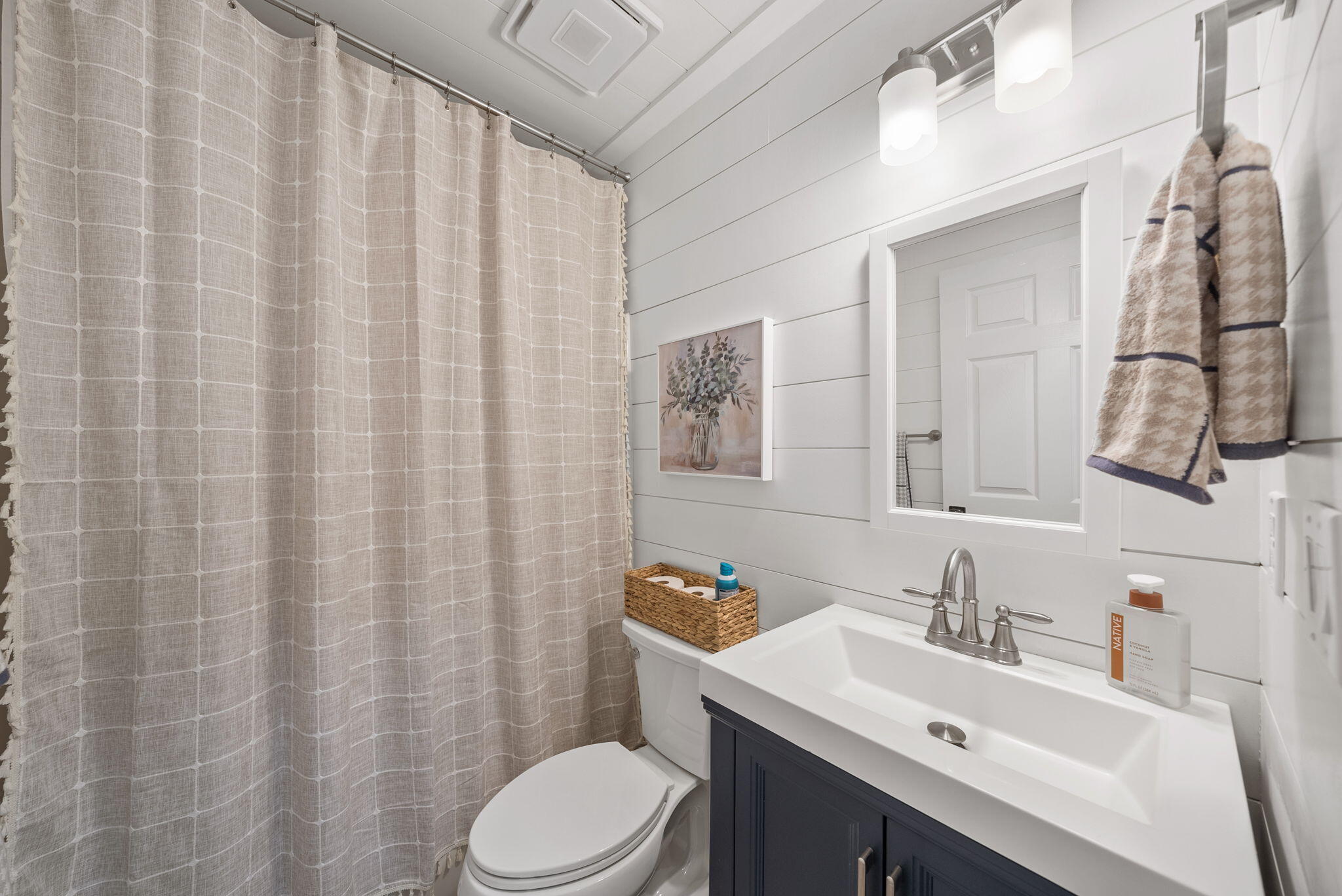 1045 Don Bishop Road Santa Rosa Beach, FL 32459 - Photo 28 of 37 a bathroom with a sink vanity mirror and toilet