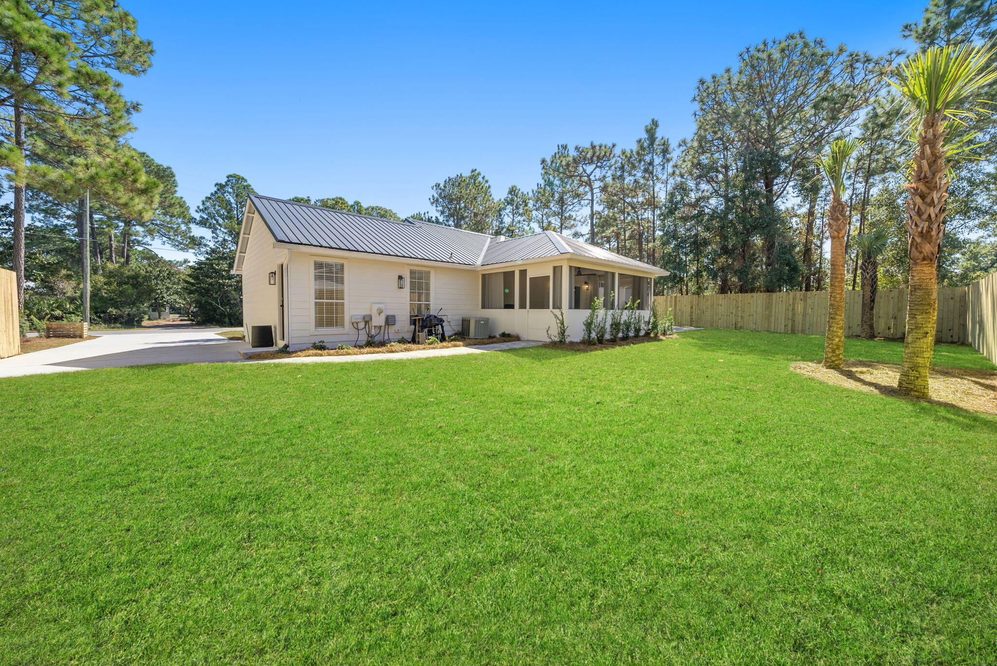1045 Don Bishop Road Santa Rosa Beach, FL 32459 - Photo 5 of 37 a view of a house with a big yard and large trees