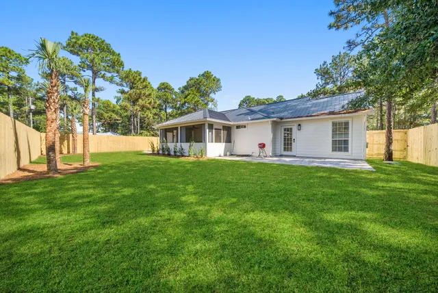 a view of a house with a backyard