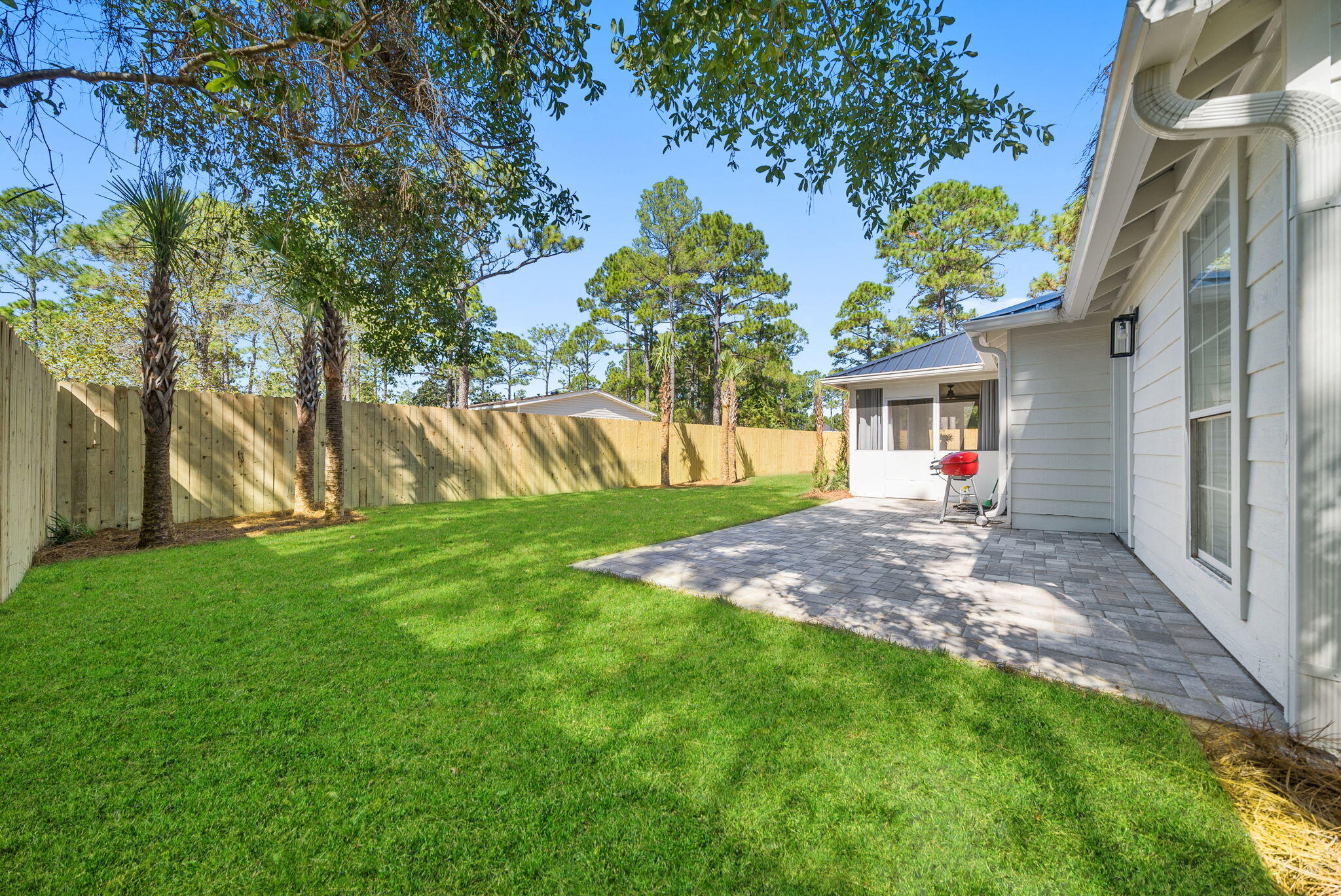 1045 Don Bishop Road Santa Rosa Beach, FL 32459 - Photo 7 of 37 a view of yard with a table and chairs under an umbrella