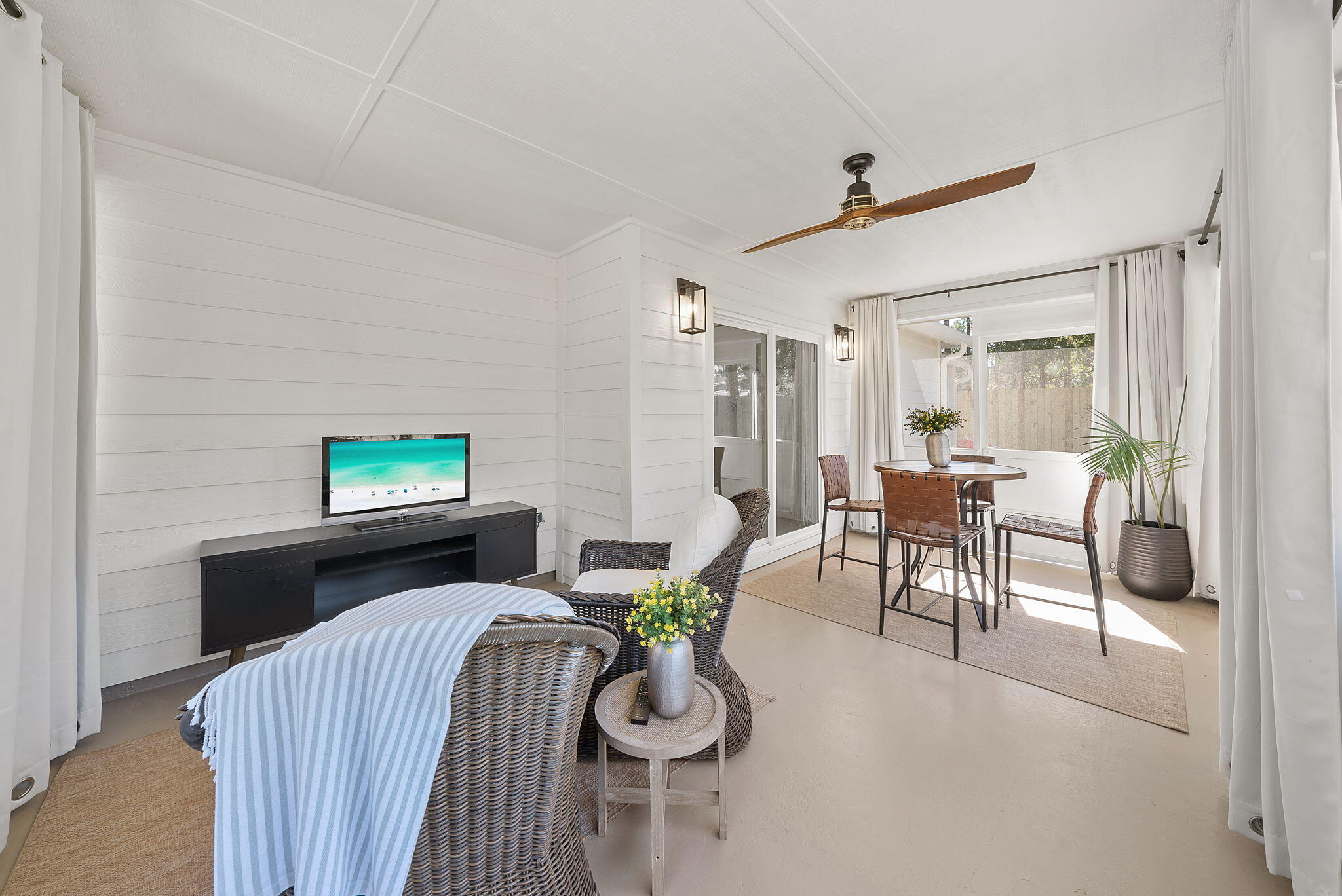 1045 Don Bishop Road Santa Rosa Beach, FL 32459 - Photo 9 of 37 a living room with furniture a flat screen tv and a large window