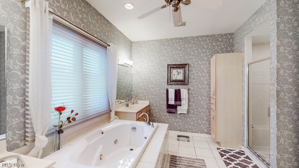 36845 Aberdeen Lane Solon, OH 44139 - Photo 13 of 24 Full master bathroom with vanity, a whirlpool tub, light tile patterned floors, a shower stall, and ceiling fan