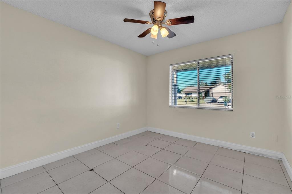 7724 Pengrove Pass Orlando, FL 32835 - Photo 5 of 24 an empty room with windows and ceiling fan