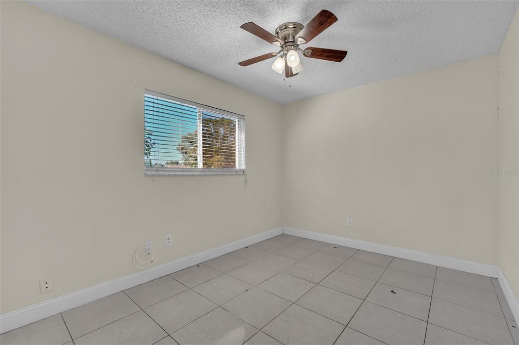 7724 Pengrove Pass Orlando, FL 32835 - Photo 8 of 24 an empty room with a window