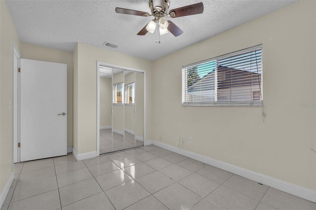 7724 Pengrove Pass Orlando, FL 32835 - Photo 9 of 24 a view of an empty room with chandelier fan and fire place
