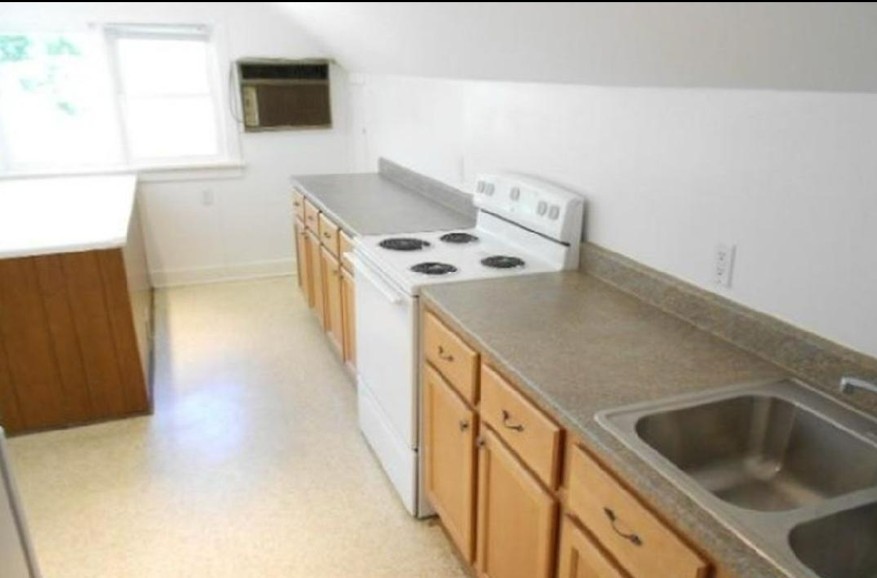 422 South Street, Unit 2 Elgin, IL 60123 - Photo 4 of 6 a kitchen with a stove and a microwave
