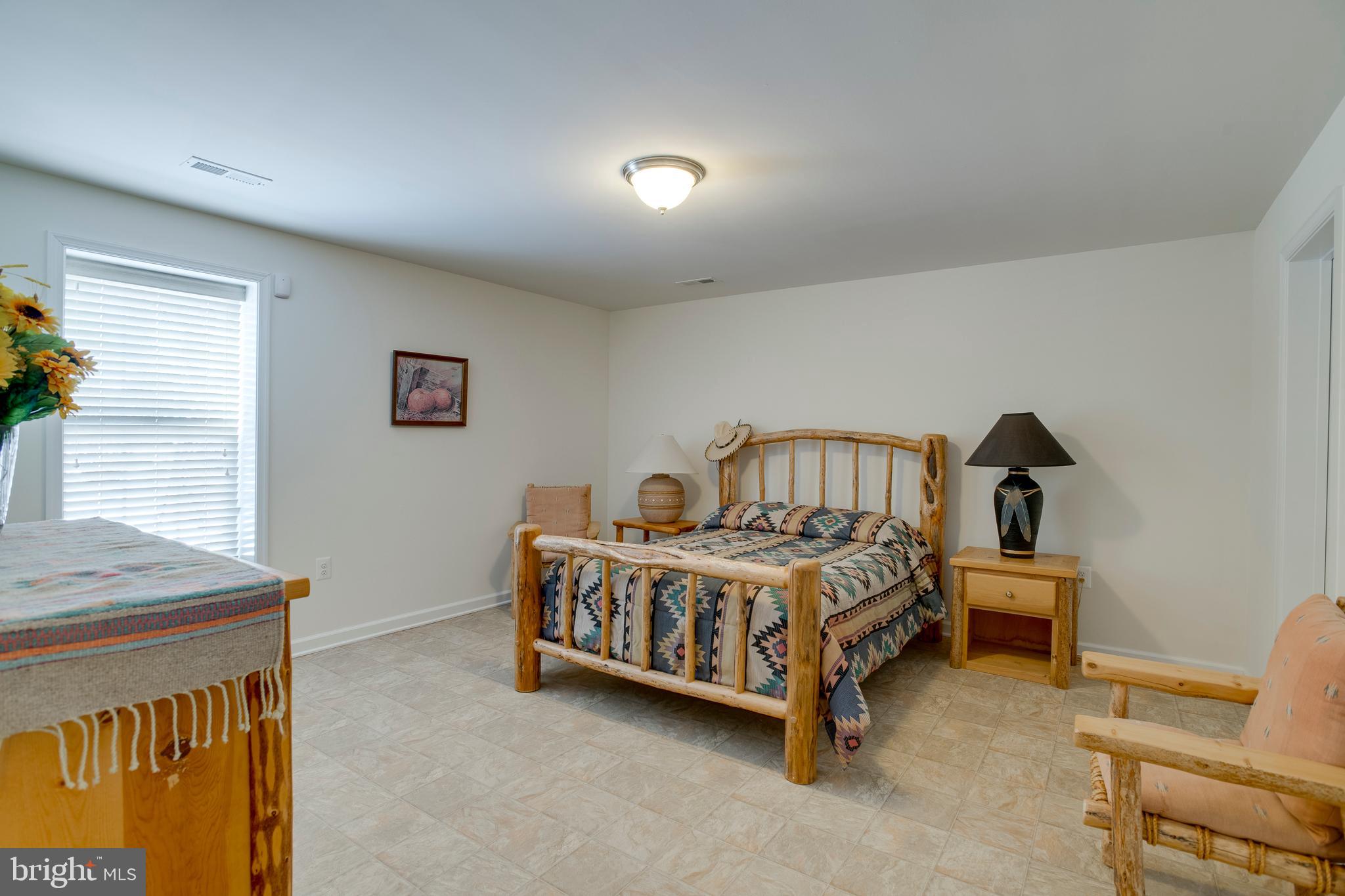 9408 Blackbird Loop Culpeper, VA 22701 - Photo 36 of 89 a bedroom with a bed and a chair