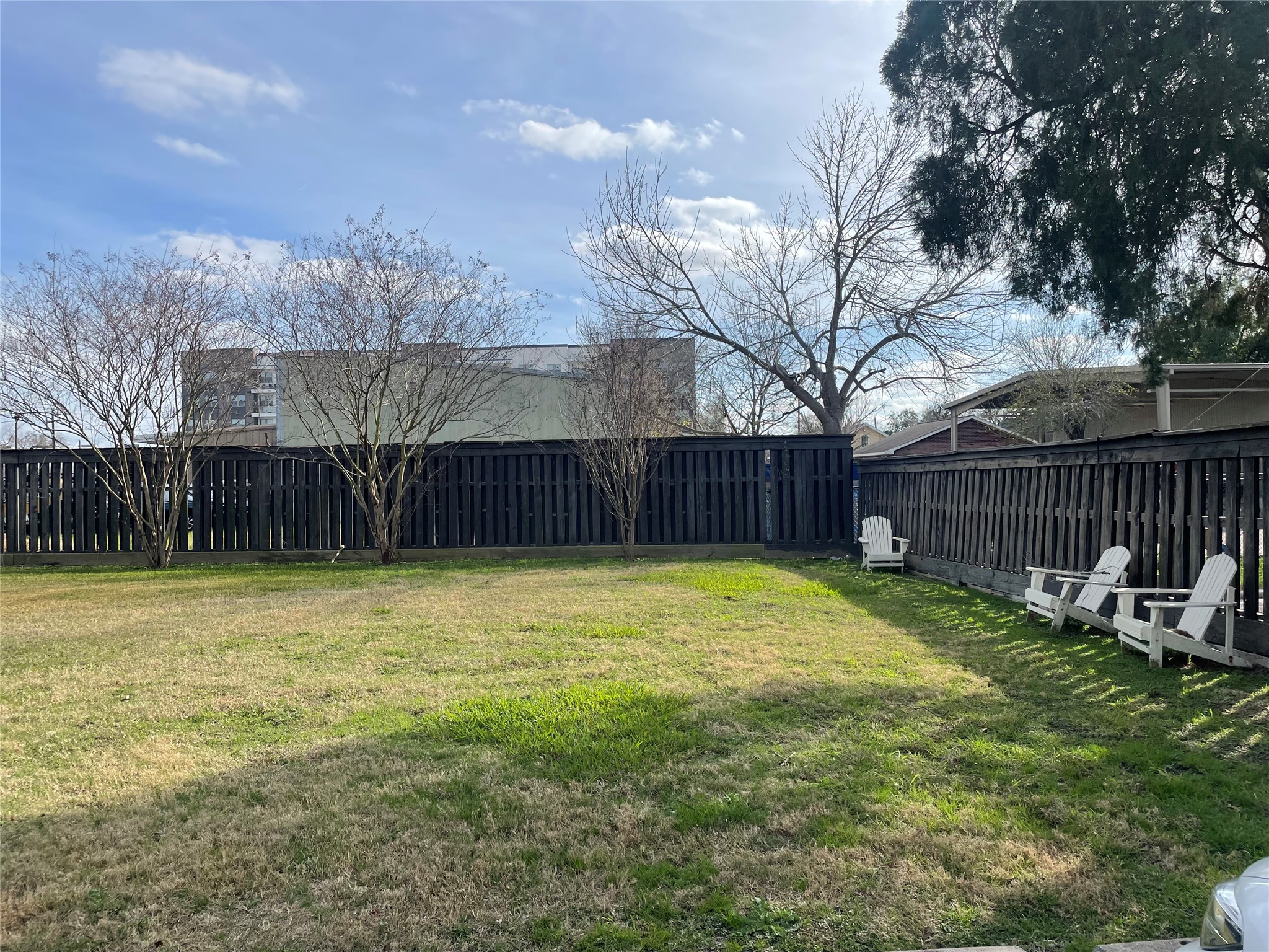 434 Lenard Street, Unit F Houston, TX 77009 - Photo 11 of 15 a view of a backyard with wooden fence and trees