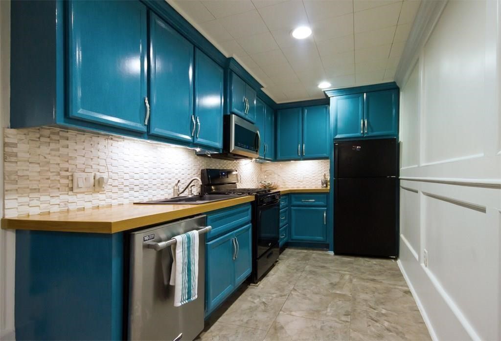 434 Lenard Street, Unit F Houston, TX 77009 - Photo 2 of 15 a kitchen with granite countertop wood cabinets and stainless steel appliances