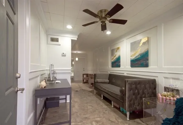 a living room with furniture and a chandelier