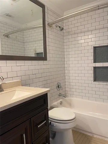 a bathroom with a sink a toilet and bathtub