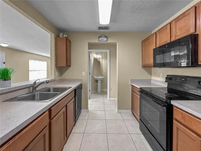 a kitchen with a sink and a stove top oven