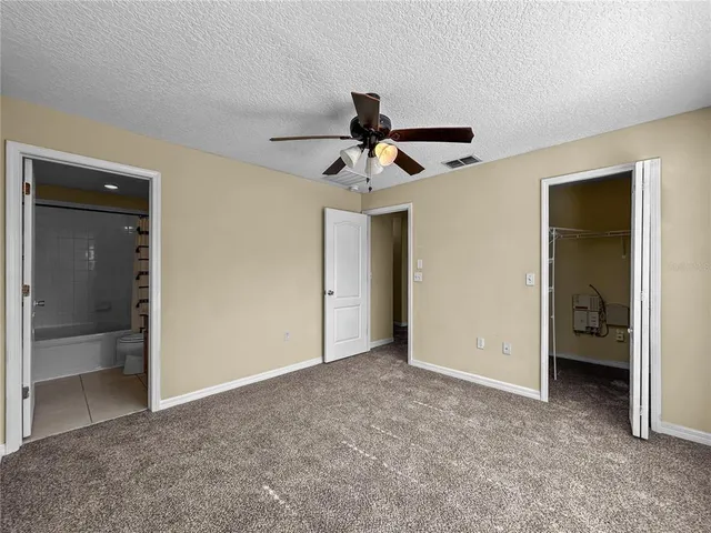 a view of a room with a ceiling fan