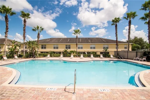 a view of a swimming pool and lounge chair
