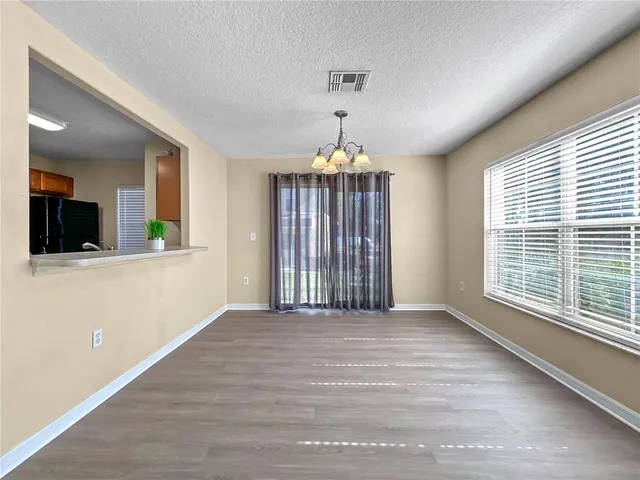 a view of a livingroom with an empty space and a window