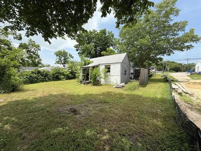 a view of a house with yard and sitting area