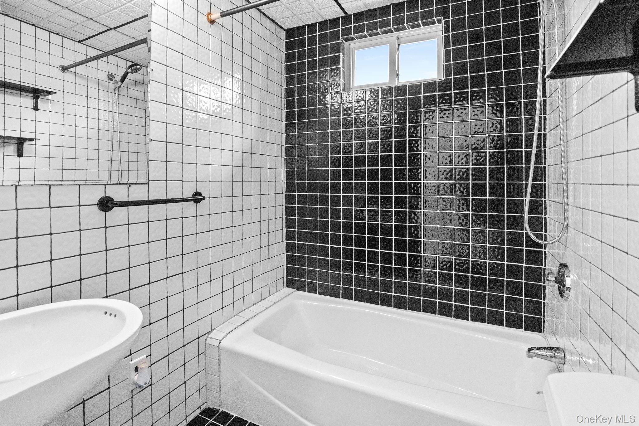 72 Hamilton Avenue New Rochelle, NY 10801 - Photo 11 of 28 a bathroom with a bathtub and sink