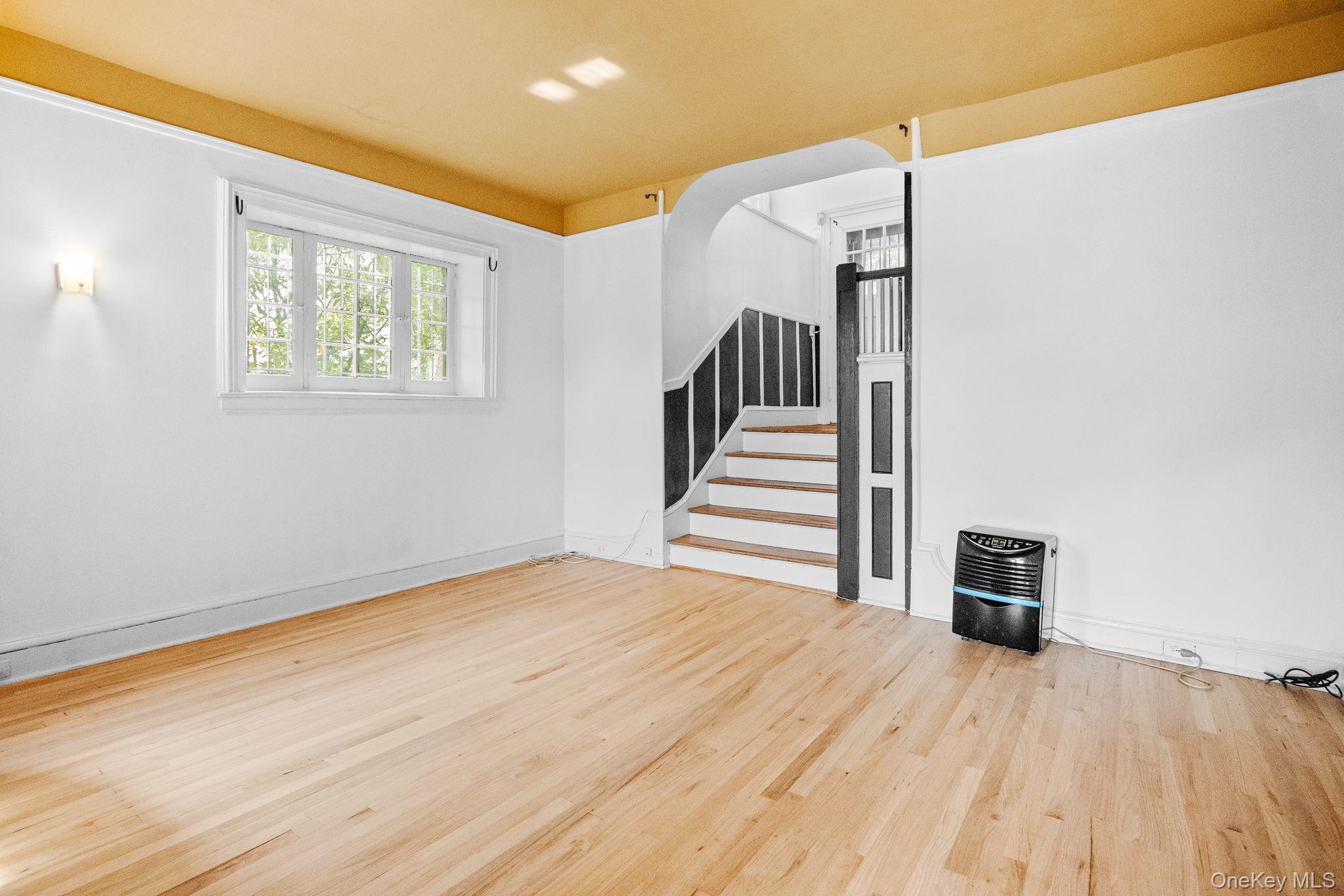 72 Hamilton Avenue New Rochelle, NY 10801 - Photo 3 of 28 a view of a room with wooden floor and stairs