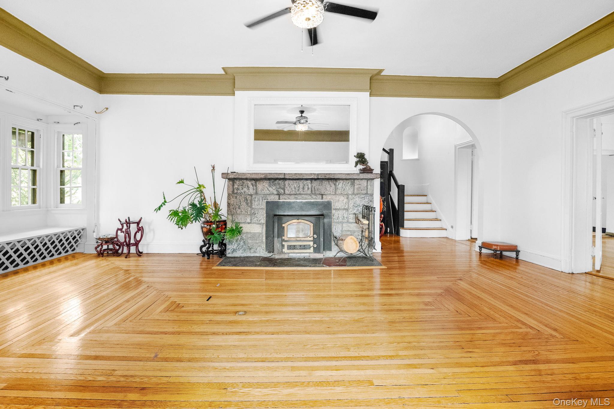 72 Hamilton Avenue New Rochelle, NY 10801 - Photo 5 of 28 a view of an empty room with a fireplace and a chandelier