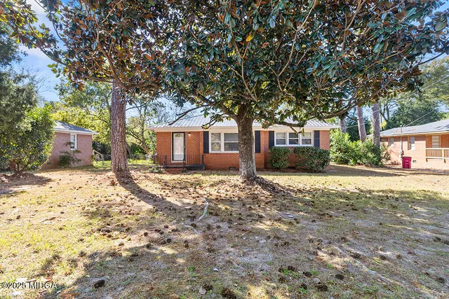 a house with trees in front of it