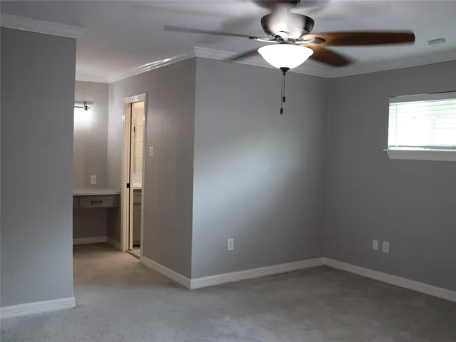 an empty room with closet and a chandelier fan