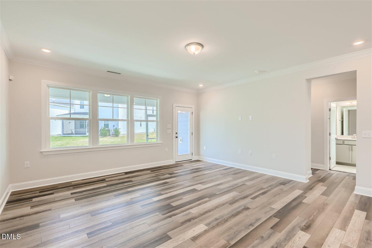 124 Fablewood Trail Garner, NC 27529 - Photo 3 of 27 a view of empty room with wooden floor and fan