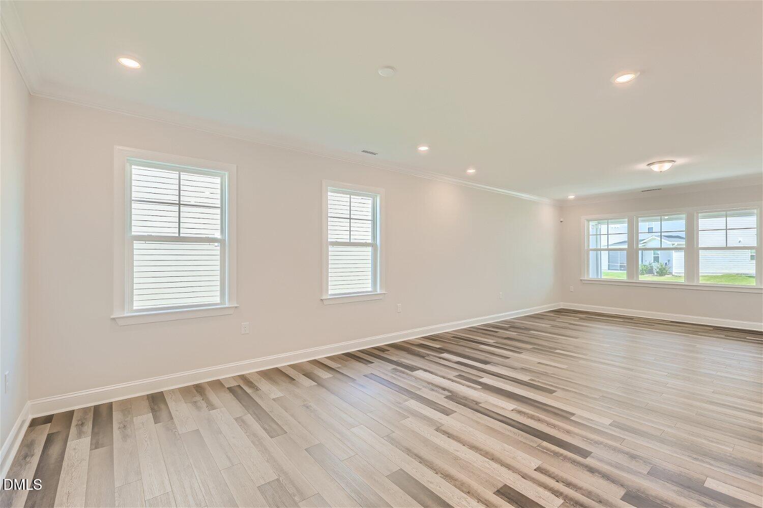 124 Fablewood Trail Garner, NC 27529 - Photo 4 of 27 a view of an empty room with wooden floor and a window