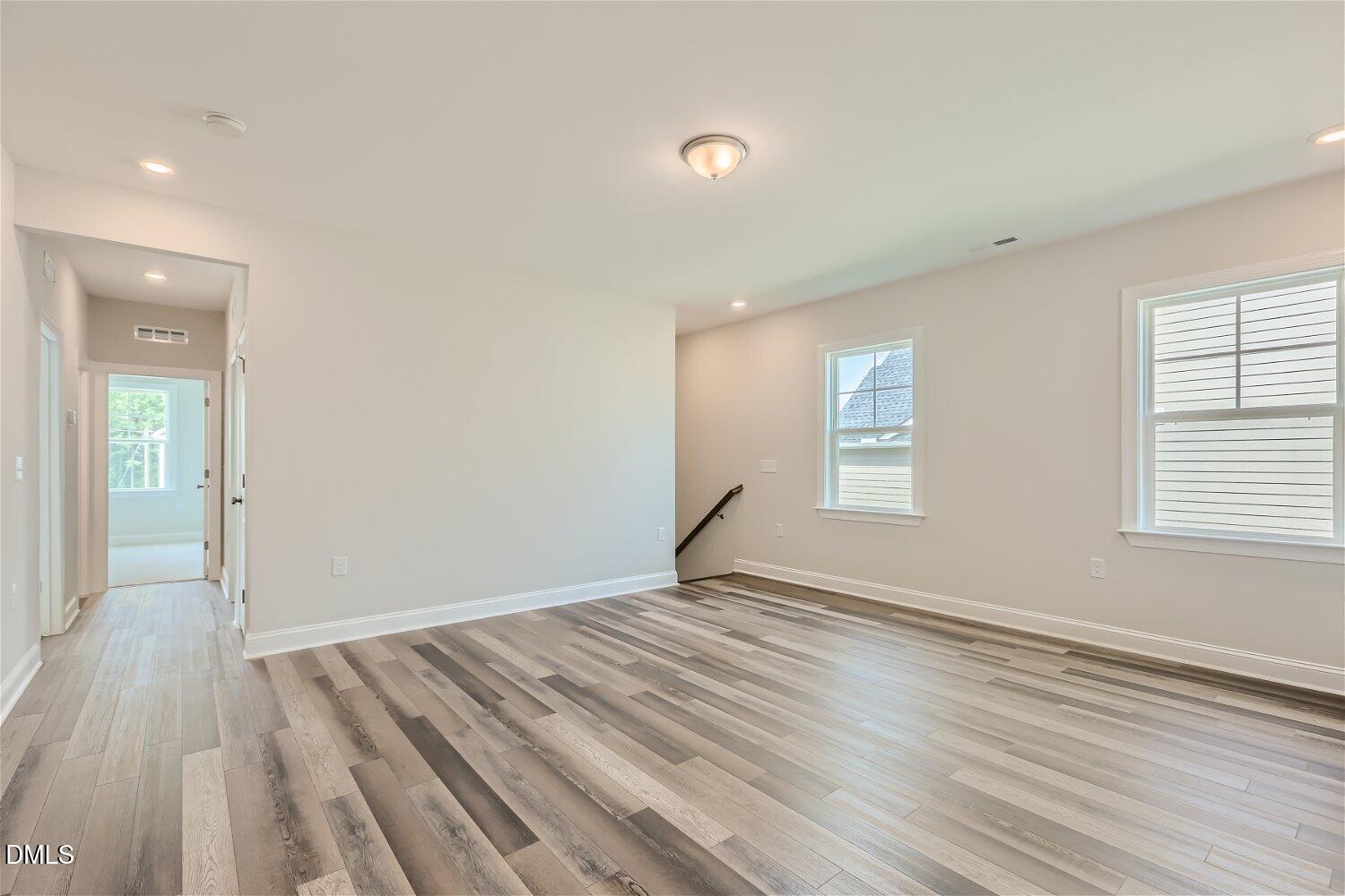 124 Fablewood Trail Garner, NC 27529 - Photo 5 of 27 wooden floor in an empty room with a window