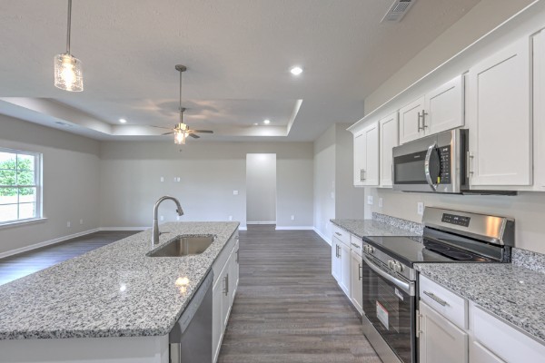 21 Bartow Street Decherd, TN 37324 - Photo 13 of 30 a kitchen with stainless steel appliances granite countertop a sink dishwasher a stove and a microwave oven with granite countertops
