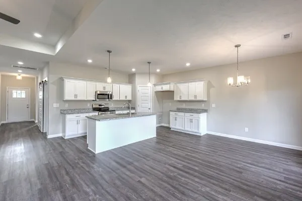a view of kitchen with kitchen island stainless steel appliances sink and cabinets