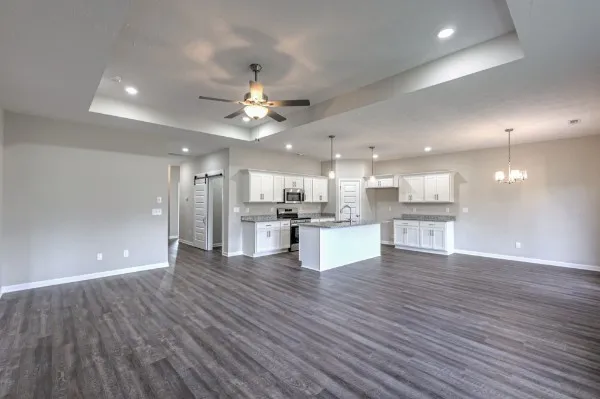 a kitchen with stainless steel appliances granite countertop a sink stove and cabinets