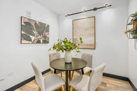 a view of a dining room with furniture and a potted plant