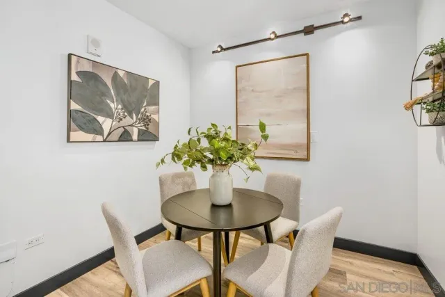 a view of a dining room with furniture and a potted plant