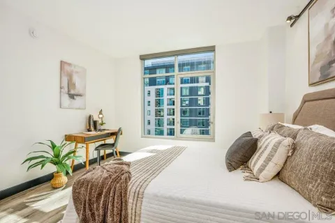 a bedroom with a bed and a window