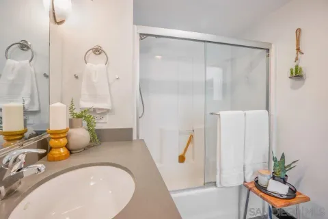 a bathroom with a granite countertop sink a toilet and a tub