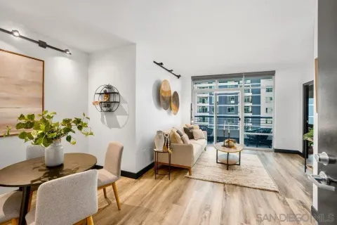a living room with furniture dining table and a potted plant