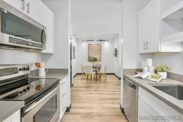 a kitchen with a stove a sink and a microwave
