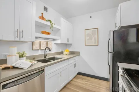 a kitchen with a sink and a refrigerator
