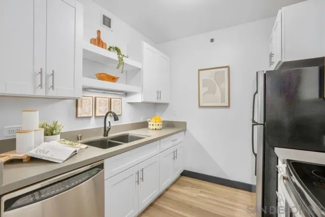 a kitchen with a sink and a refrigerator