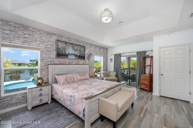 a bedroom with a large bed and a large window