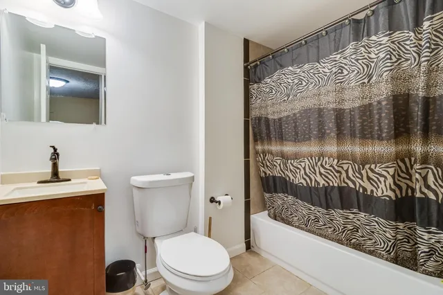 a bathroom with a toilet a sink and shower