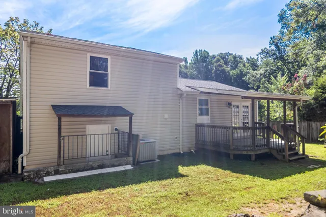 a view of a house with a wooden deck